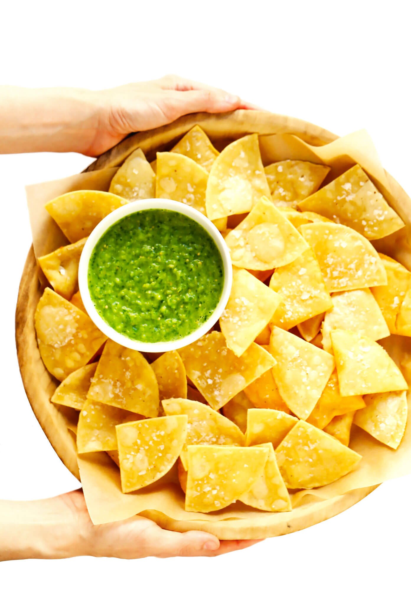 Holding a bowl of Fresh Salsa Verde with Homemade Chips