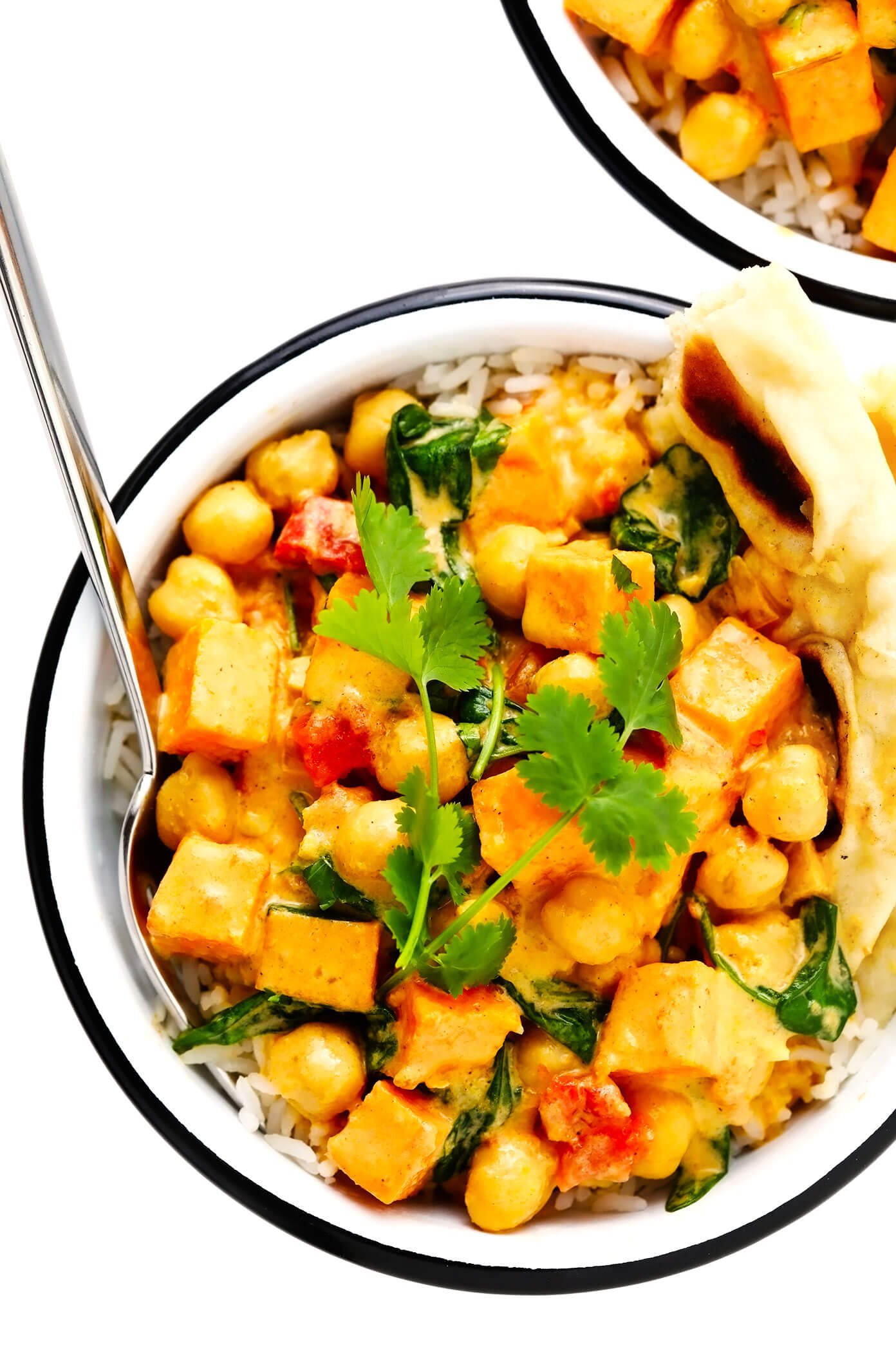 Sweet Potato Chickpea Coconut Curry in Bowl with Naan Bread and Rice