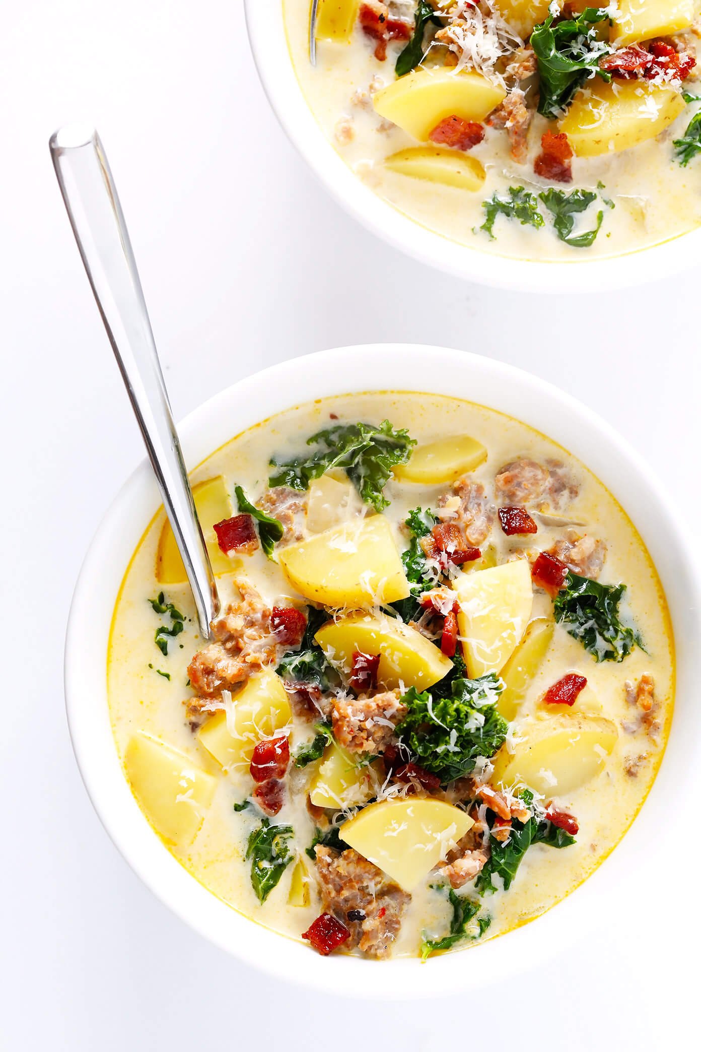 Learn how to make this favorite Olive Garden soup on the stovetop or in the slow cooker! This Zuppa Toscana recipe is super easy to make, naturally gluten-free, and full of the most delicious zesty, creamy flavors. So grab some Italian sausage, kale, potatoes, bacon, Parmesan, and garlic, and make it happen! Crock-pot instructions also included.