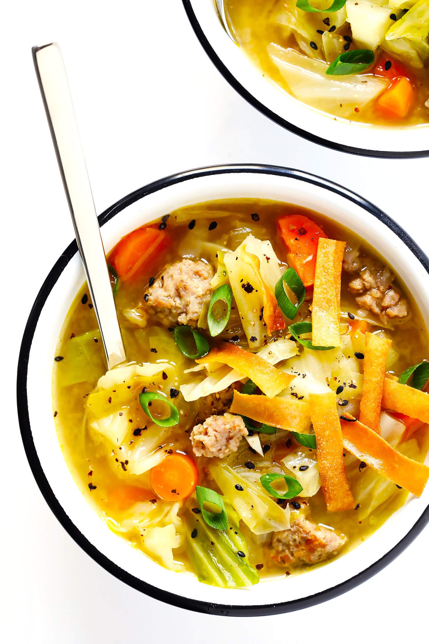 This Egg Roll Soup recipe is SO tasty!! It's basically an Asian cabbage soup, simmered with zesty sausage, carrots, sesame and ginger, and topped with crispy wonton strips if desired. It's the perfect easy dinner recipe. | Gimme Some Oven #glutenfree #soup #recipe #gf