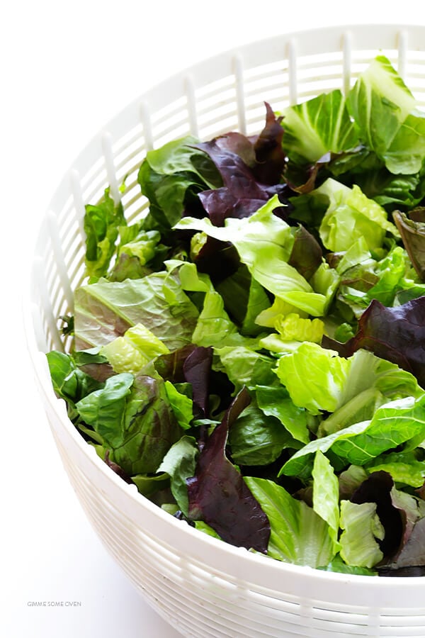 Our Family's Favorite Salad is made with lots of artichoke hearts, roasted red peppers, toasted pine nuts, and a zesty Parmesan vinaigrette. SO delicious, and always a crowd pleaser! | gimmesomeoven.com