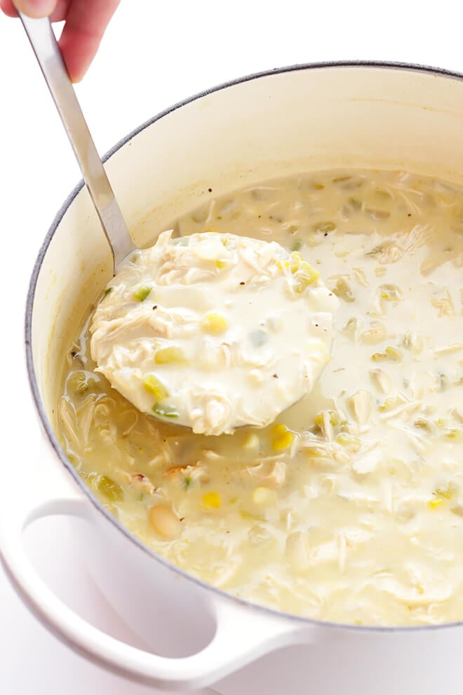 This Creamy White Chicken Chili recipe only takes 30 minutes to make, and it's full of the best, comforting, creamy flavors. So delicious, and easy to make gluten-free if you'd like. | gimmesomeoven.com