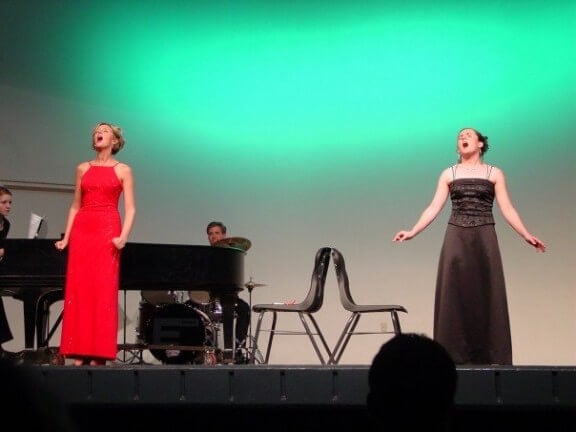 Monica and me, circa 2005, belting out a duet at her senior recital.