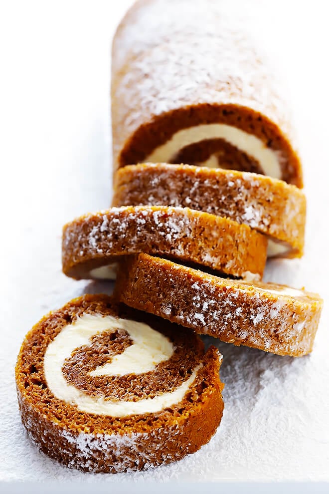 Learn how to make this classic pumpkin roll recipe with a step-by-step photo and video tutorial! It's easy to make ahead of time, it's filled with a heavenly cream cheese filling, and it's always a crowd favorite!! | gimmesomeoven.com