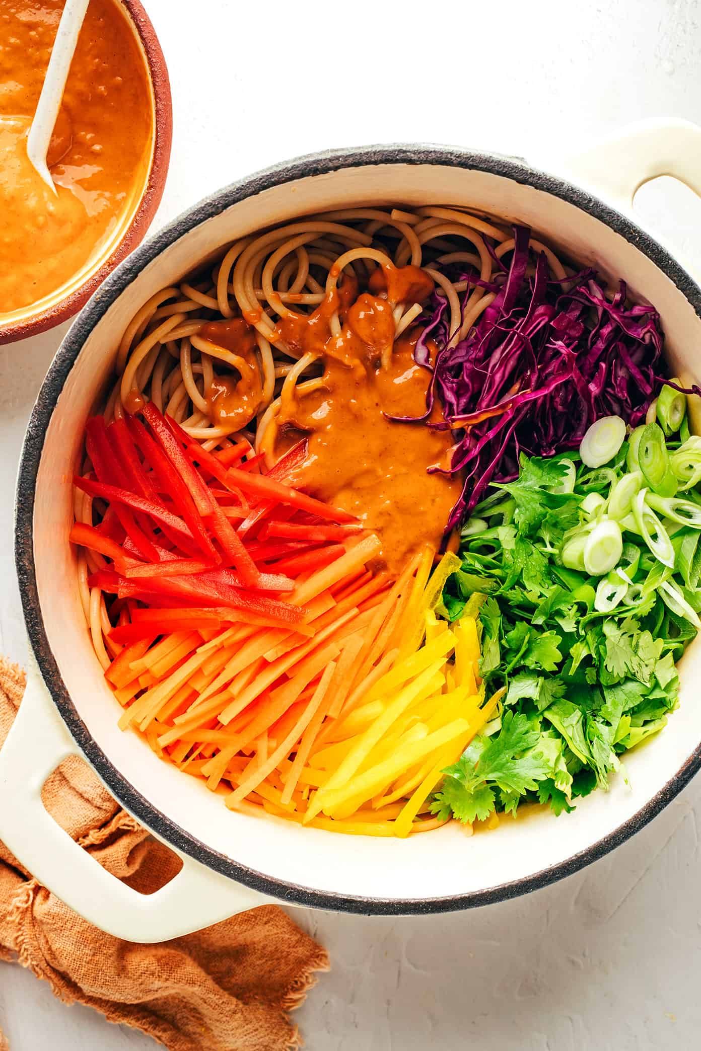 Mixing together rainbow peanut noodles