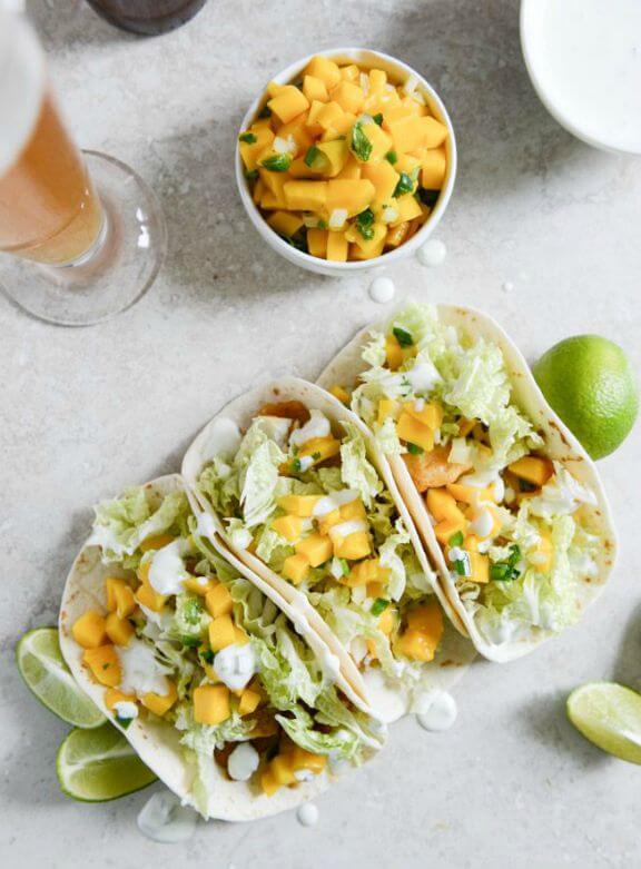 Beer Battered Fish Tacos with Margarita Mango Salsa and Jalapeño Crema | howsweeteats.com