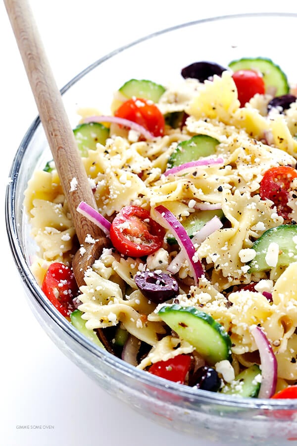 This Mediterranean Pasta Salad is SO GOOD! Love all of those cucumbers, tomatoes, Kalamata olives, red onions, and feta cheese. Perfect for a potluck! | gimmesomeoven.com