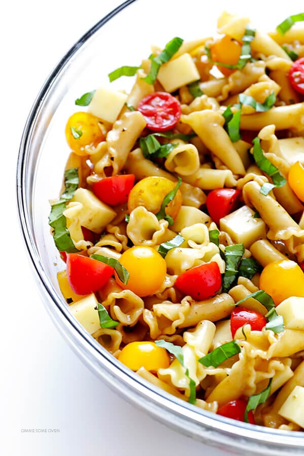 This Caprese Pasta Salad Recipe is quick and easy to make, tossed with a delicious balsamic vinaigrette, and perfect for picnics, potlucks, or just a regular weeknight meal! | gimmesomeoven.com