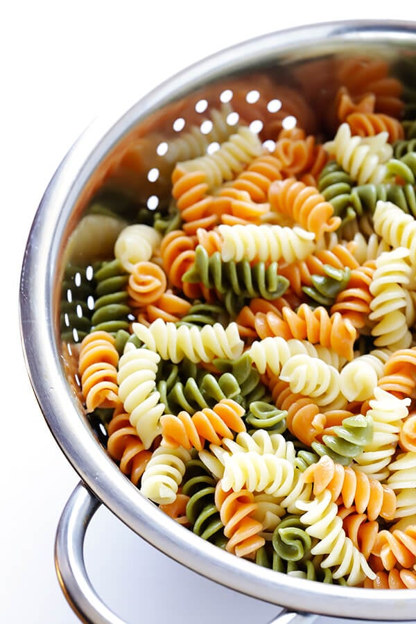 This Rainbow Antipasto Pasta Salad is the perfect way to use up leftover antipasto ingredients! Plus, it's easy to make, tossed with a zesty Italian herb vinaigrette, and absolutely delicious! | gimmesomeoven.com