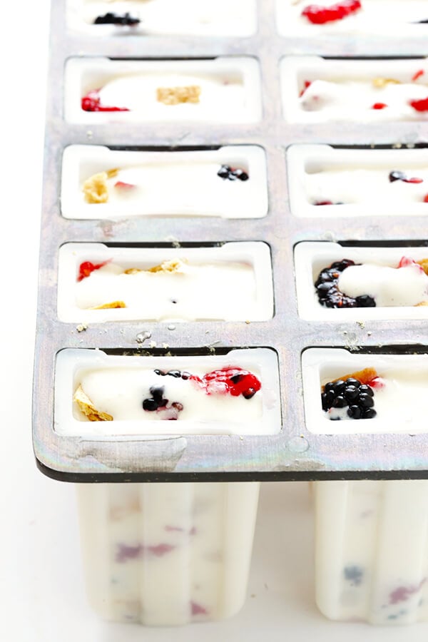 These Berry Cheesecake Popsicles are quick and easy to prep, they're chocked full of fresh berries and graham crackers, and they really do taste like cheesecake! | gimmesomeoven.com