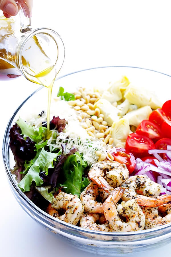 This Shrimp and Artichoke Green Salad is made with easy Italian-herb shrimp, artichoke hearts, tomatoes, pine nuts, and then it's tossed in a zesty lemon vinaigrette. It's one of my all-time favorite salads! | gimmesomeoven.com