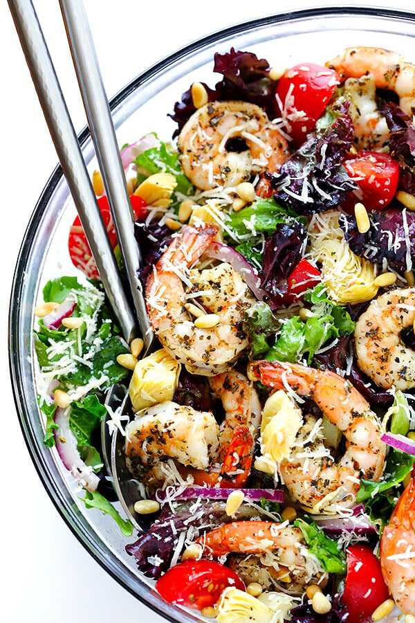 This Shrimp and Artichoke Green Salad is made with easy Italian-herb shrimp, artichoke hearts, tomatoes, pine nuts, and then it's tossed in a zesty lemon vinaigrette. It's one of my all-time favorite salads! | gimmesomeoven.com