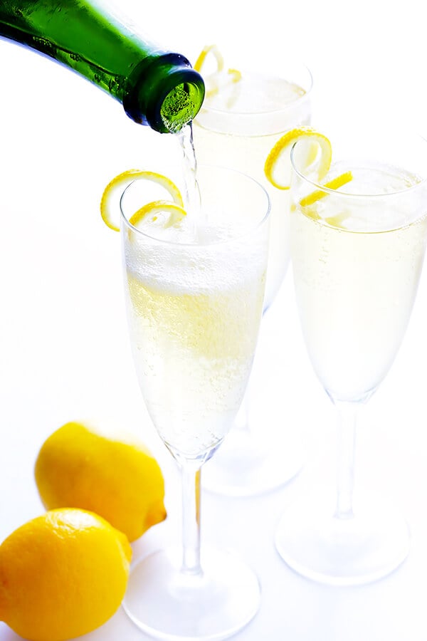 This classic French 75 cocktail recipe is made with sparkling champagne, gin, fresh lemon juice, and lightly sweetened with sugar (or honey) simple syrup. So delicious and refreshing! | gimmesomeoven.com