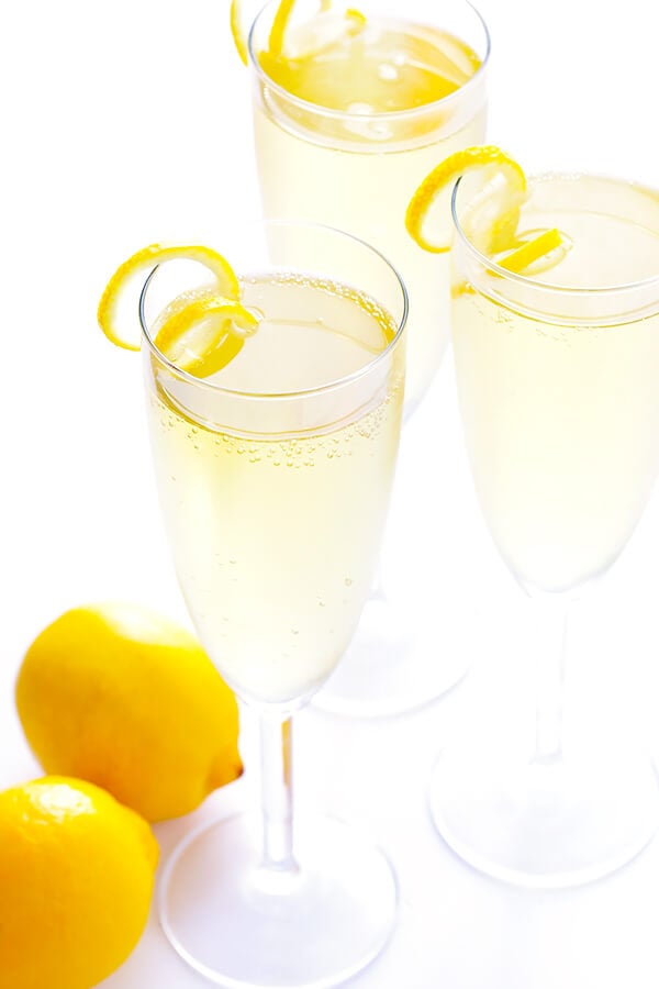 This classic French 75 cocktail recipe is made with sparkling champagne, gin, fresh lemon juice, and lightly sweetened with sugar (or honey) simple syrup. So delicious and refreshing! | gimmesomeoven.com