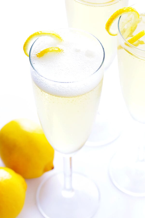 This classic French 75 cocktail recipe is made with sparkling champagne, gin, fresh lemon juice, and lightly sweetened with sugar (or honey) simple syrup. So delicious and refreshing! | gimmesomeoven.com