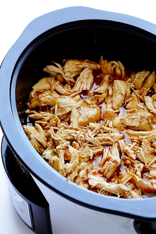 These Slow Cooker Crispy Chicken Carnitas are made easy by simmering for hours in the crock pot, then they're briefly crisped up in the broiler, resulting in tender, crispy, juicy, and absolutely DELICIOUS chicken carnitas. Perfect for tacos, burritos, or whatever sounds good! | gimmesomeoven.com