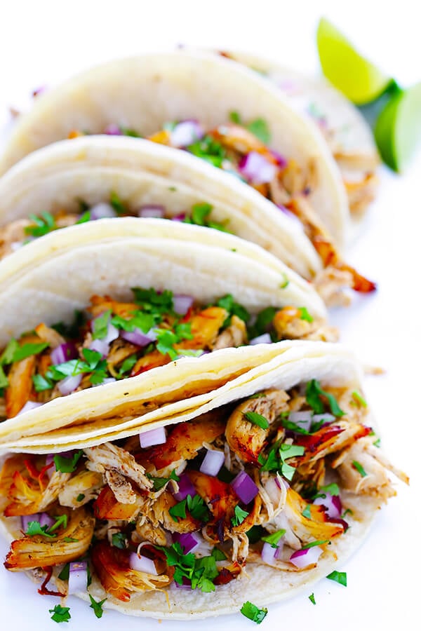 These Slow Cooker Crispy Chicken Carnitas are made easy by simmering for hours in the crock pot, then they're briefly crisped up in the broiler, resulting in tender, crispy, juicy, and absolutely DELICIOUS chicken carnitas. Perfect for tacos, burritos, or whatever sounds good! | gimmesomeoven.com