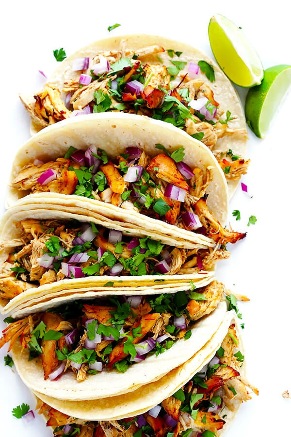 These Slow Cooker Crispy Chicken Carnitas are made easy by simmering for hours in the crock pot, then they're briefly crisped up in the broiler, resulting in tender, crispy, juicy, and absolutely DELICIOUS chicken carnitas. Perfect for tacos, burritos, or whatever sounds good! | gimmesomeoven.com