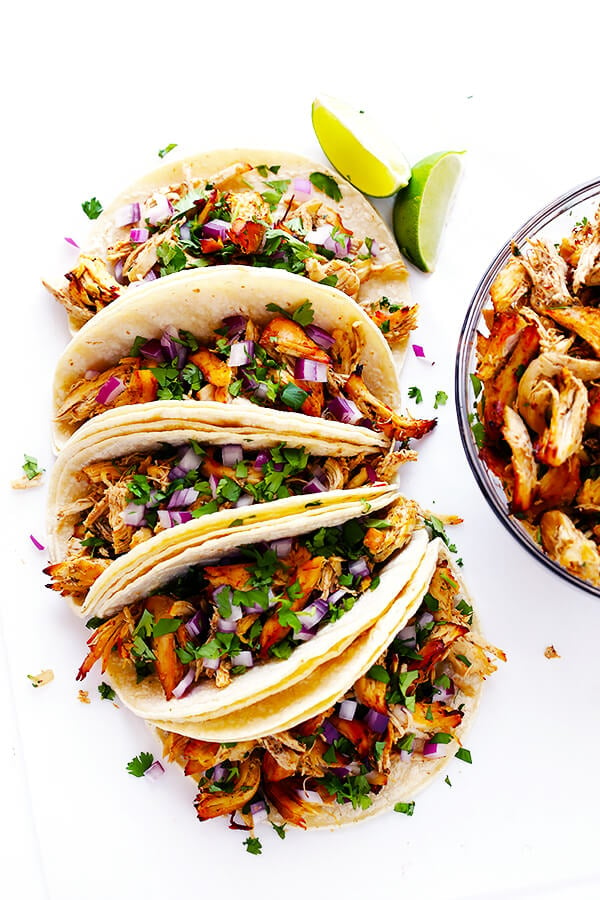 These Slow Cooker Crispy Chicken Carnitas are made easy by simmering for hours in the crock pot, then they're briefly crisped up in the broiler, resulting in tender, crispy, juicy, and absolutely DELICIOUS chicken carnitas. Perfect for tacos, burritos, or whatever sounds good! | gimmesomeoven.com