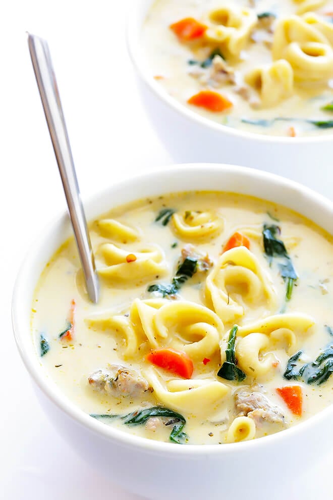 This Creamy Tortellini Soup with Italian Sausage is an absolute WINNER. It's made with a rich and creamy broth (made without heavy cream!), cheesy tortellini, zesty Italian sausage, and lots of greens and veggies. Total, delicious comfort food! | gimmesomeoven.com