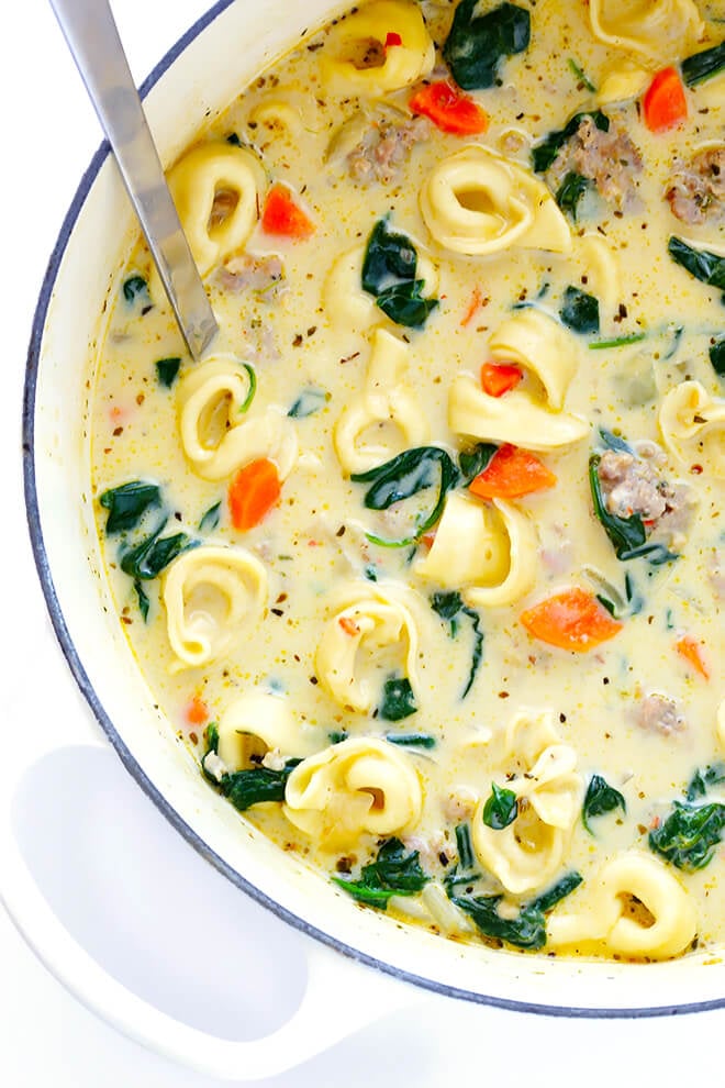 This Creamy Tortellini Soup with Italian Sausage is an absolute WINNER. It's made with a rich and creamy broth (made without heavy cream!), cheesy tortellini, zesty Italian sausage, and lots of greens and veggies. Total, delicious comfort food! | gimmesomeoven.com