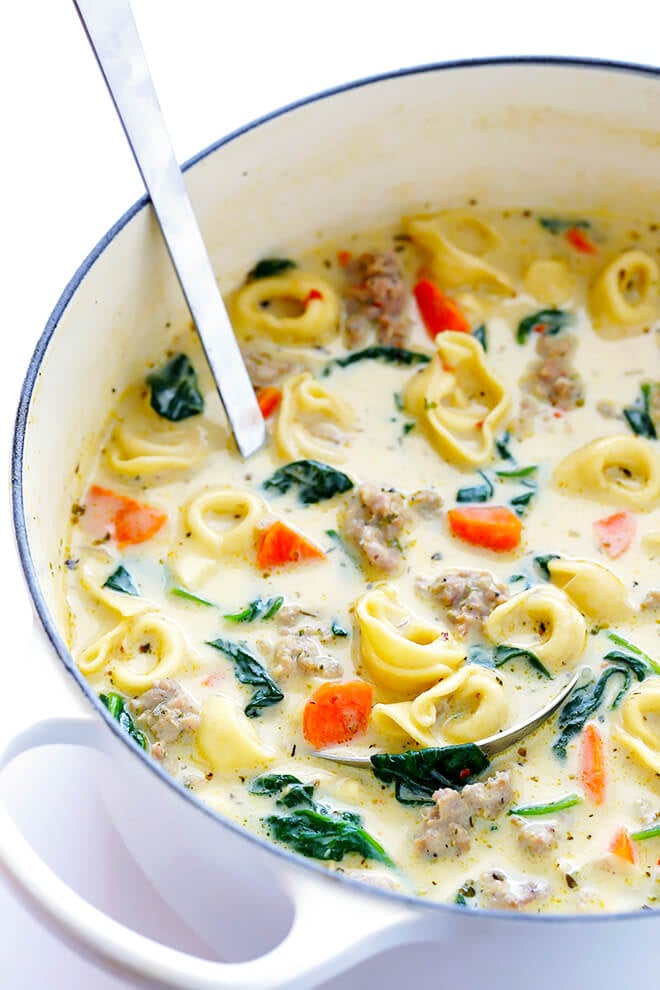 This Creamy Tortellini Soup with Italian Sausage is an absolute WINNER. It's made with a rich and creamy broth (made without heavy cream!), cheesy tortellini, zesty Italian sausage, and lots of greens and veggies. Total, delicious comfort food! | gimmesomeoven.com