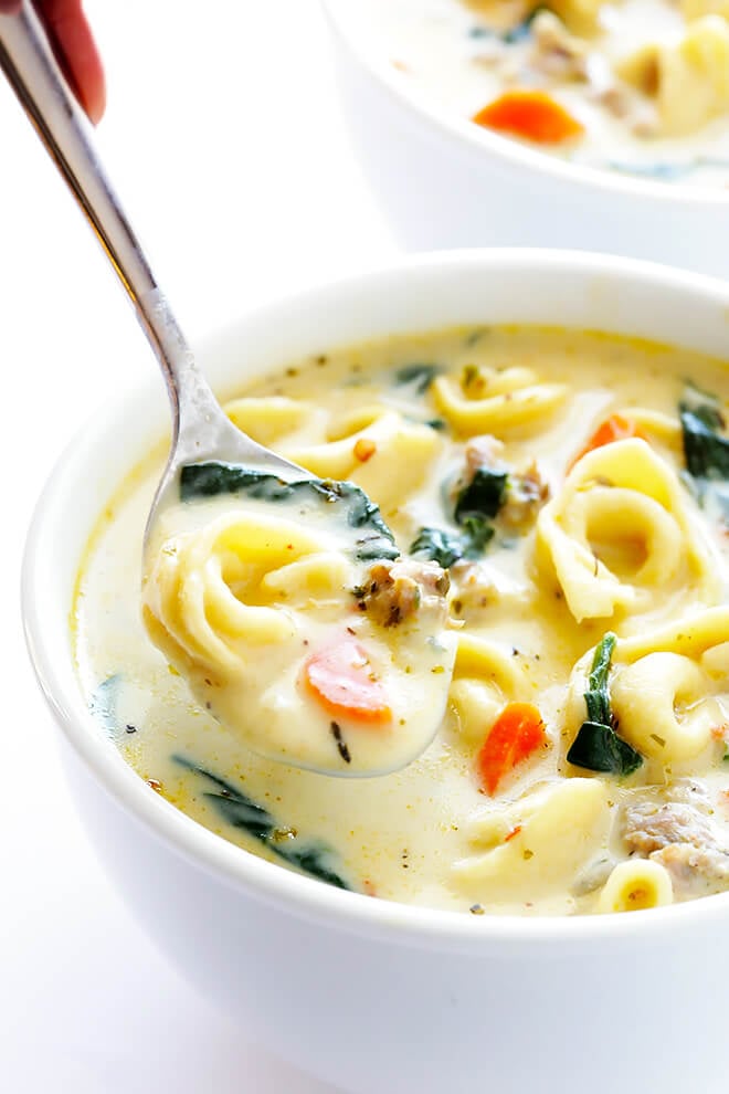 This Creamy Tortellini Soup with Italian Sausage is an absolute WINNER. It's made with a rich and creamy broth (made without heavy cream!), cheesy tortellini, zesty Italian sausage, and lots of greens and veggies. Total, delicious comfort food! | gimmesomeoven.com