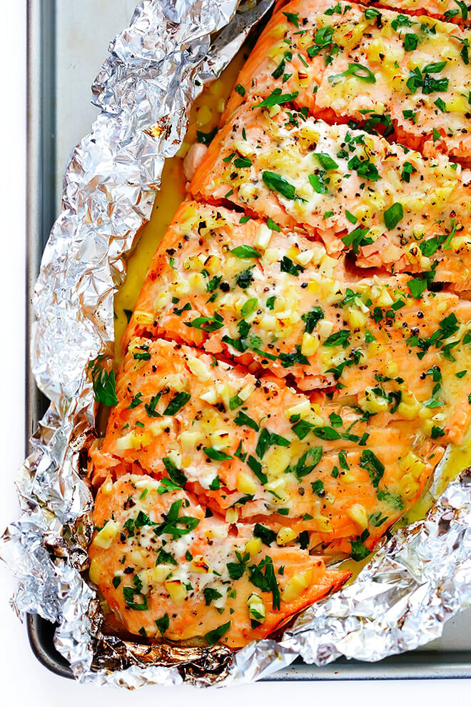 This Garlic Lovers Salmon In Foil recipe only takes a few minutes to prep, it's made with a SUPER delicious lemon garlic butter sauce, and it's always a crowd pleaser! Directions included for how cook it on the grill or in the oven. | gimmesomeoven.com