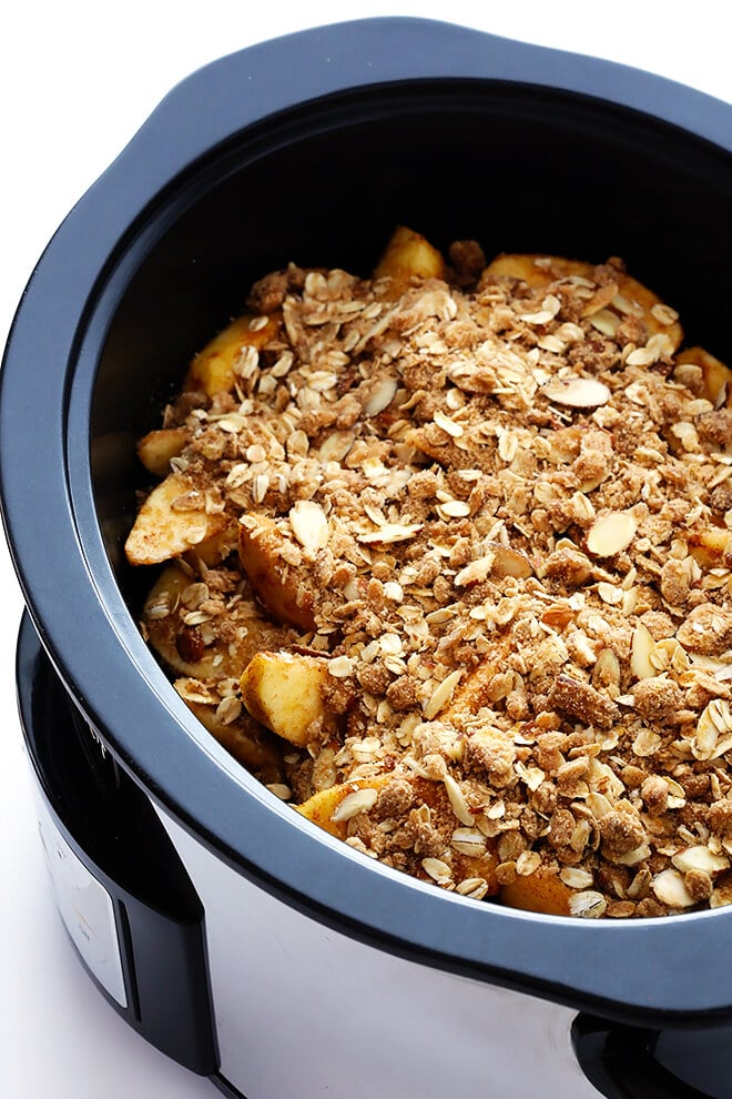 This Slow Cooker Apple Crisp recipe is easy to make in the crock-pot, and it's made with the most delicious warm cinnamon apples and crisp oatmeal-almond topping! | gimmesomeoven.com (Gluten-Free / Vegan / Vegetarian)