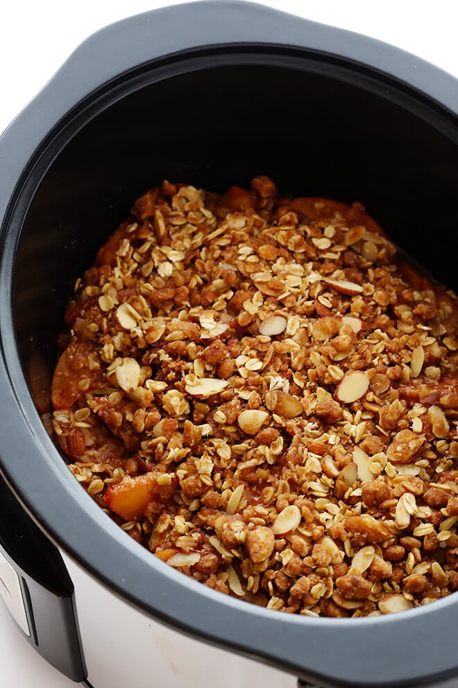 This Slow Cooker Apple Crisp recipe is easy to make in the crock-pot, and it's made with the most delicious warm cinnamon apples and crisp oatmeal-almond topping! | gimmesomeoven.com (Gluten-Free / Vegan / Vegetarian)