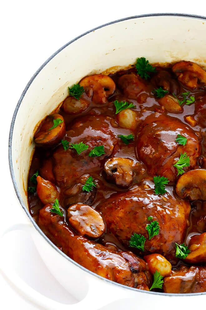 This classic Coq Au Vin recipe is surprisingly easy to make, and slow simmered in the most delicious French red wine sauce. | gimmesomeoven.com