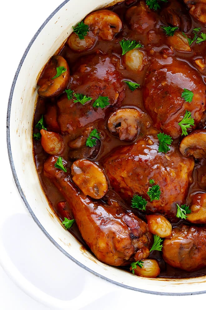 This classic Coq Au Vin recipe is surprisingly easy to make, and slow simmered in the most delicious French red wine sauce. | gimmesomeoven.com