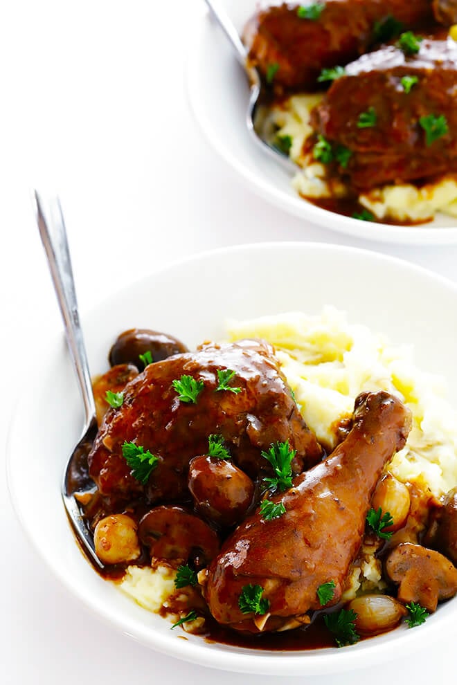 This classic Coq Au Vin recipe is surprisingly easy to make, and slow simmered in the most delicious French red wine sauce. | gimmesomeoven.com