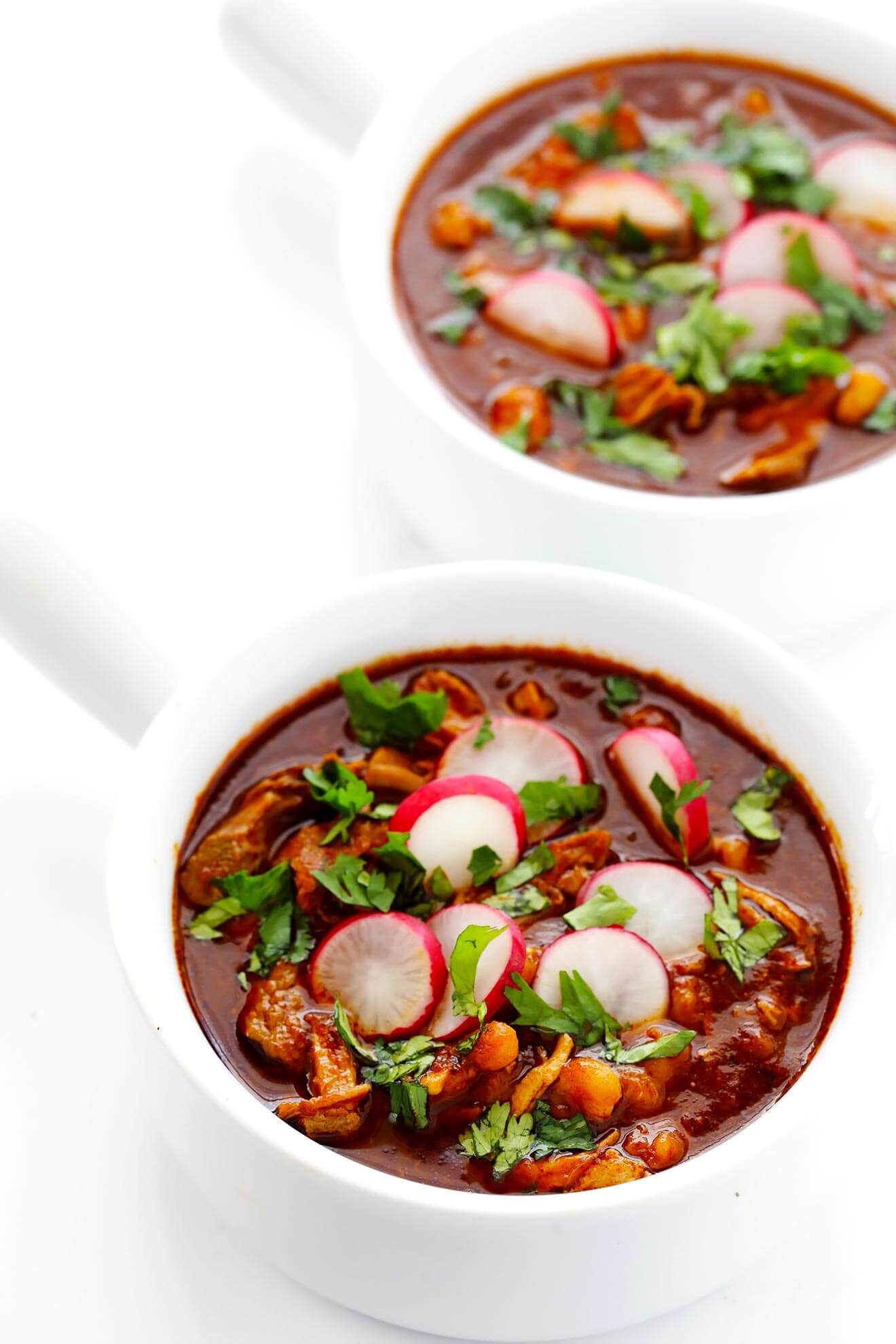 This AMAZING Posole Rojo (Mexican pork stew) is slow-simmered with the most delicious chile broth, and it's so comforting and flavorful. | gimmesomeoven.com (Gluten-Free)