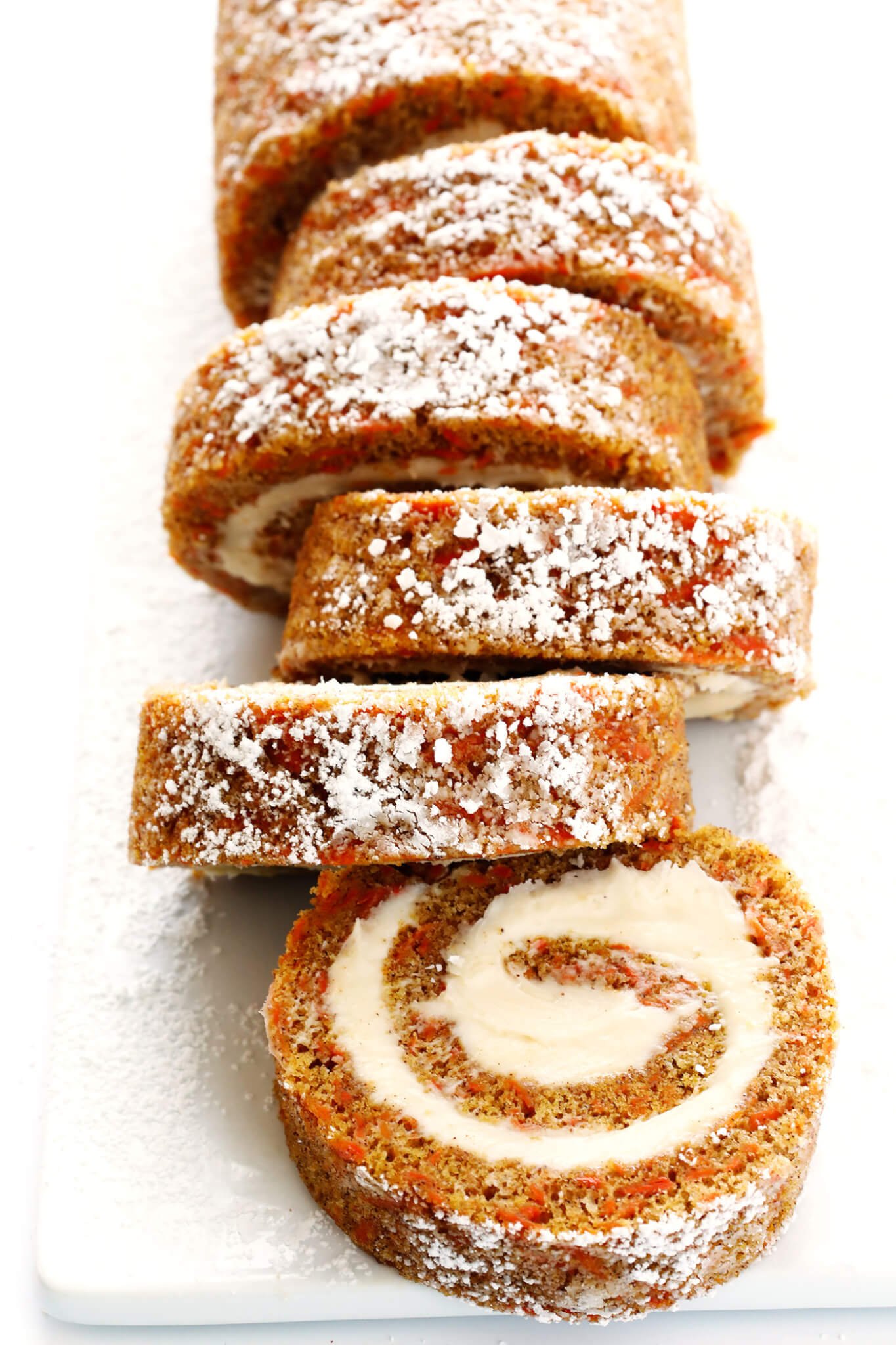 Everything you love about carrot cake...rolled up with cream cheese filling into this delicious Carrot Cake Roll! Such a fun dessert! | gimmesomeoven.com
