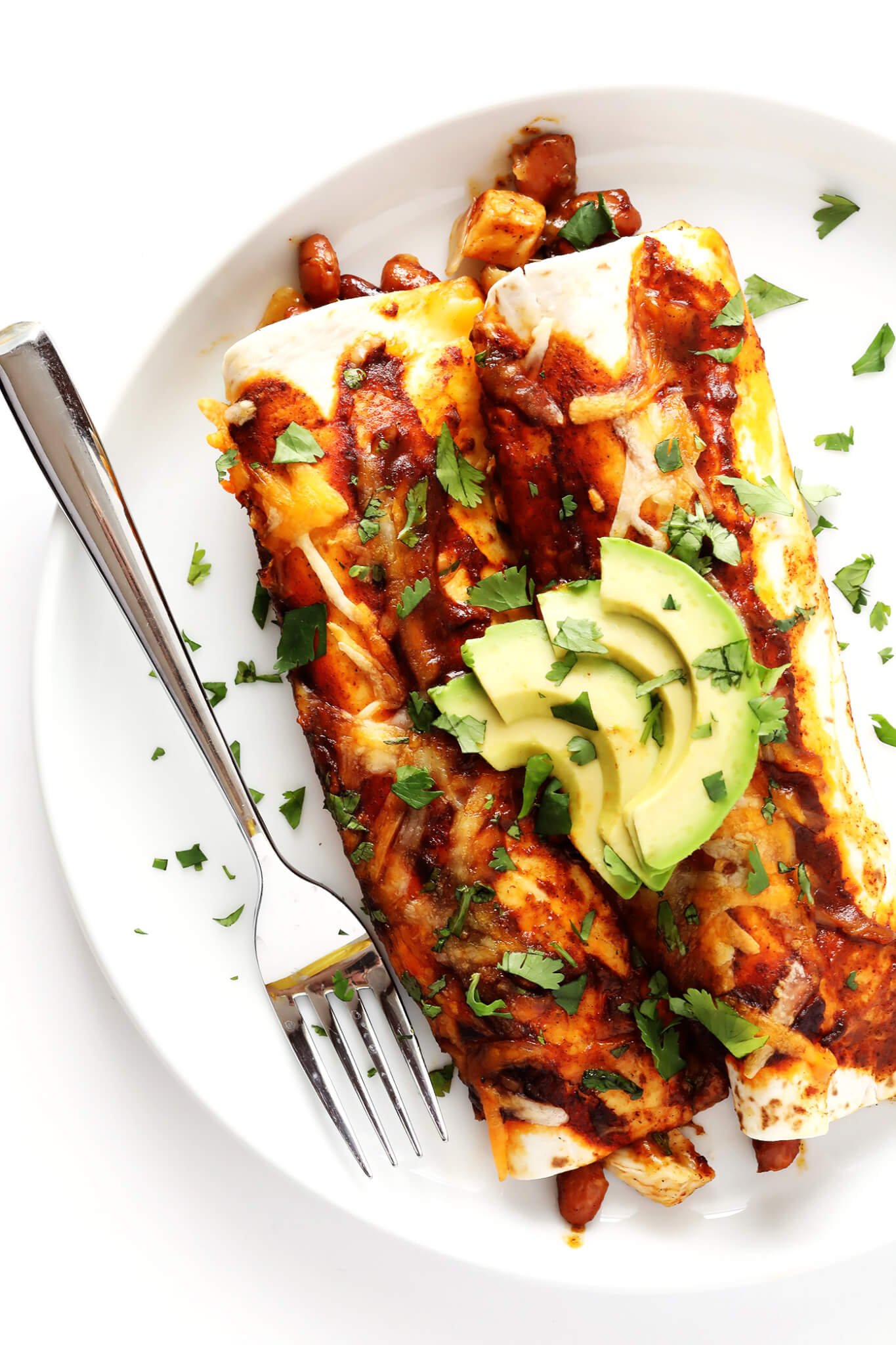 This Ancho Chicken Enchiladas recipe is easy to make, full of big flavor, nice and cheesy and filled with chicken and beans, and perfect for Cinco de Mayo or anytime you're feeling like Mexican food! | gimmesomeoven.com