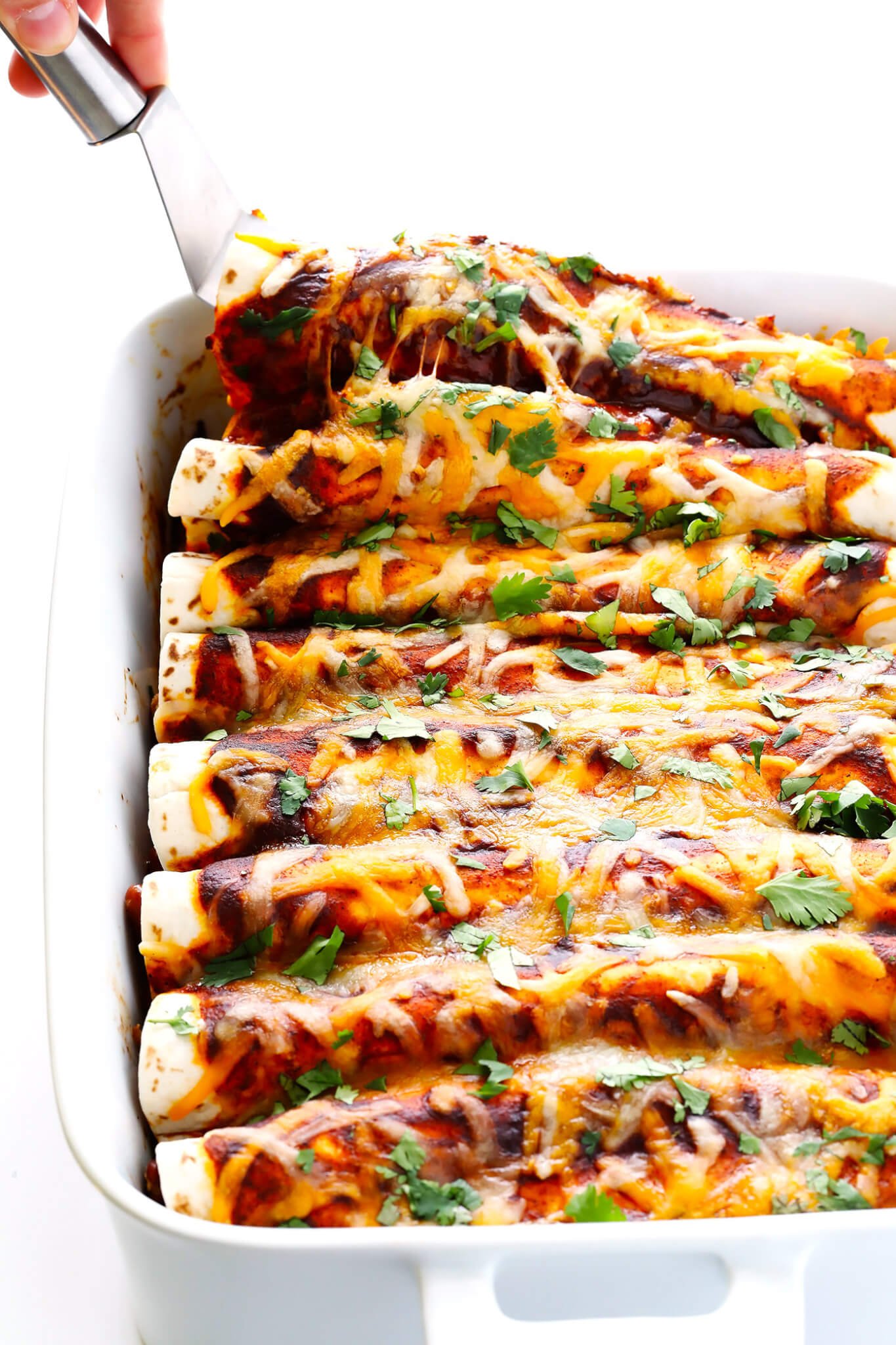 This Ancho Chicken Enchiladas recipe is easy to make, full of big flavor, nice and cheesy and filled with chicken and beans, and perfect for Cinco de Mayo or anytime you're feeling like Mexican food! | gimmesomeoven.com