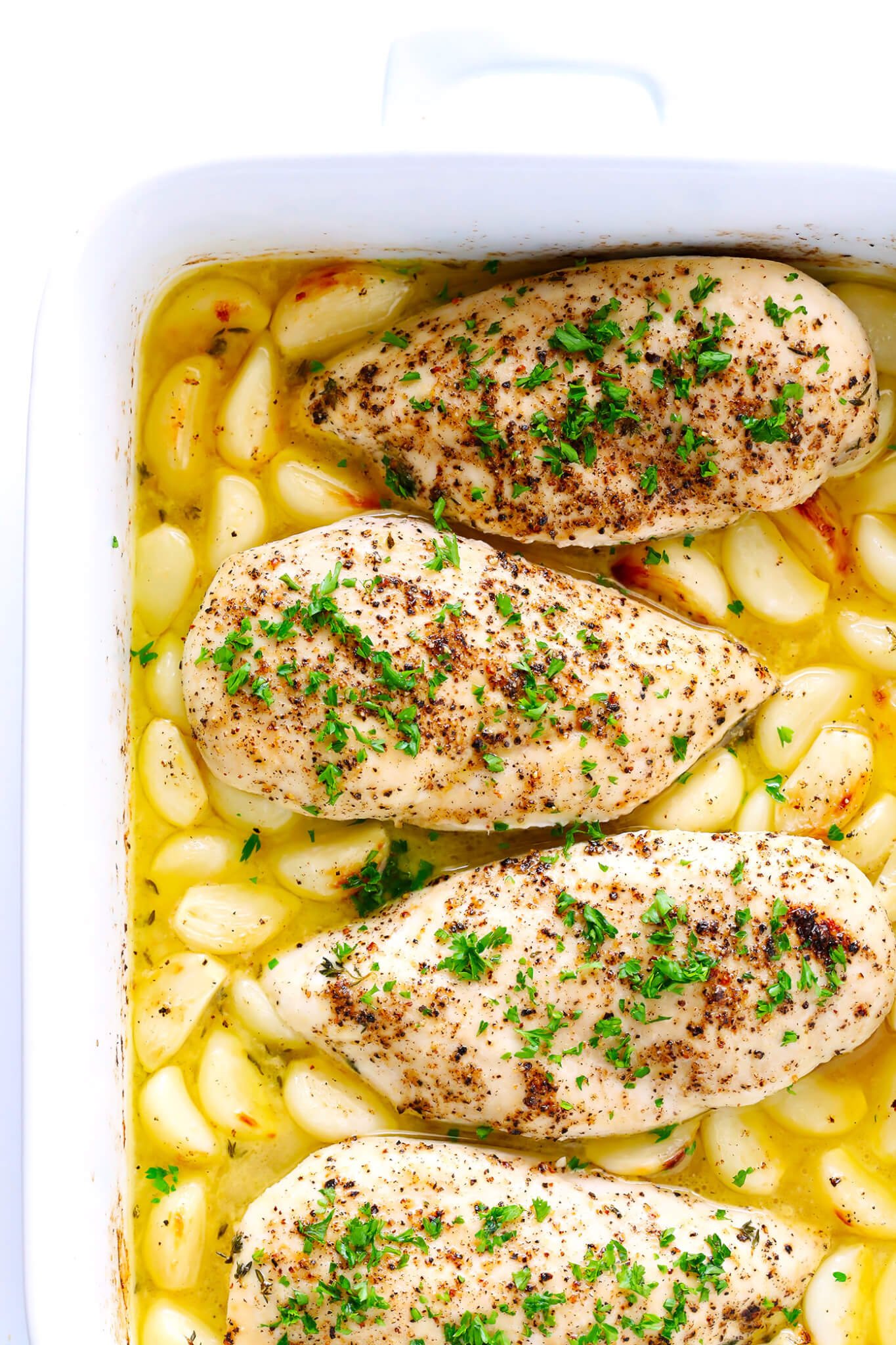 This Garlic Lovers Baked Chicken recipe is quick and easy to prepare, it's baked in the oven with a delicious lemon-butter sauce, and it's made with 40 cloves of garlic that are roasted to perfection. It's also naturally gluten-free, and SO delicious. An awesome weeknight dinner idea!