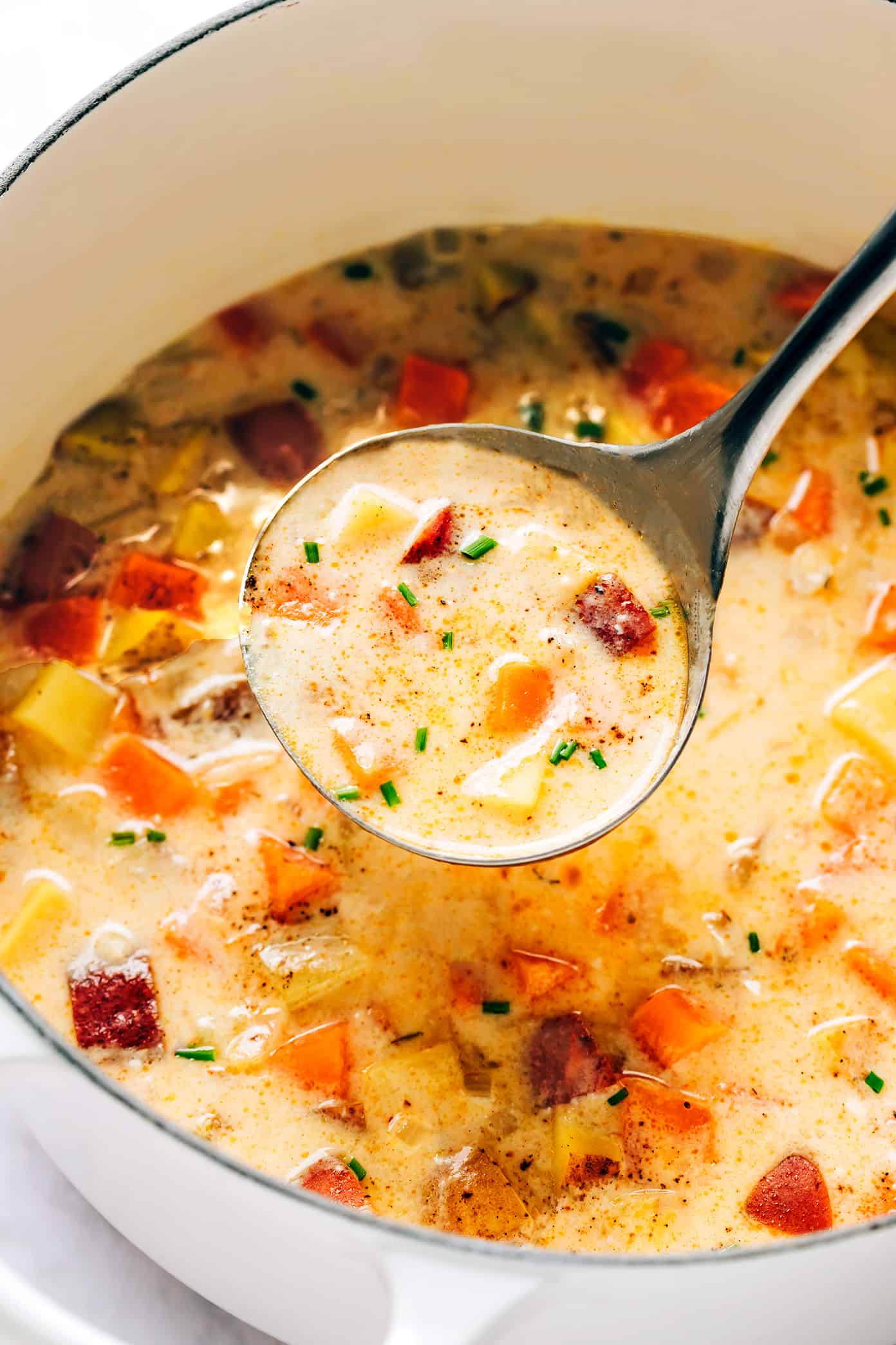 Pot full of three potato soup with ladle