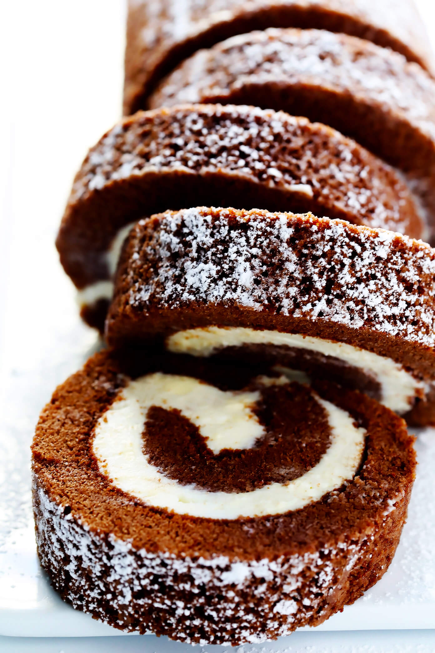 This amazing Chocolate Roll Recipe (a.k.a. "Chocolate Swiss Roll") is easy to customize with your favorite fillings (cream cheese is my fave!). Plus, it's also easy to make ahead and freeze. Perfect for holiday entertaining, and even giving away as gifts! | Gimme Some Oven #chocolate #cake #christmas #dessert