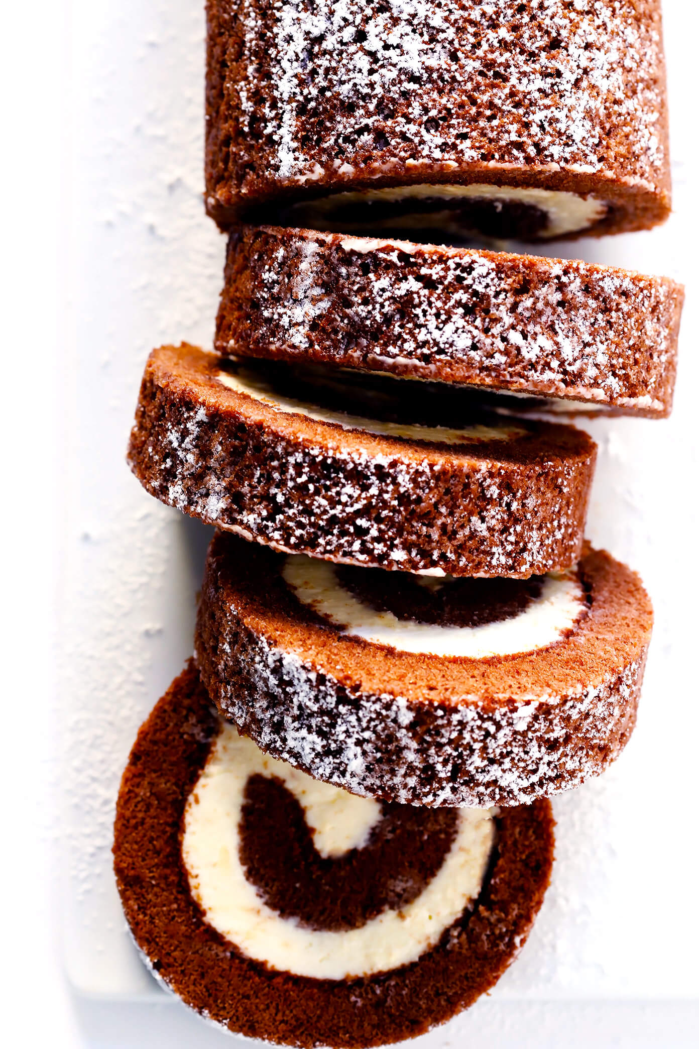 This amazing Chocolate Roll Recipe (a.k.a. "Chocolate Swiss Roll") is easy to customize with your favorite fillings (cream cheese is my fave!). Plus, it's also easy to make ahead and freeze. Perfect for holiday entertaining, and even giving away as gifts! | Gimme Some Oven #chocolate #cake #christmas #dessert