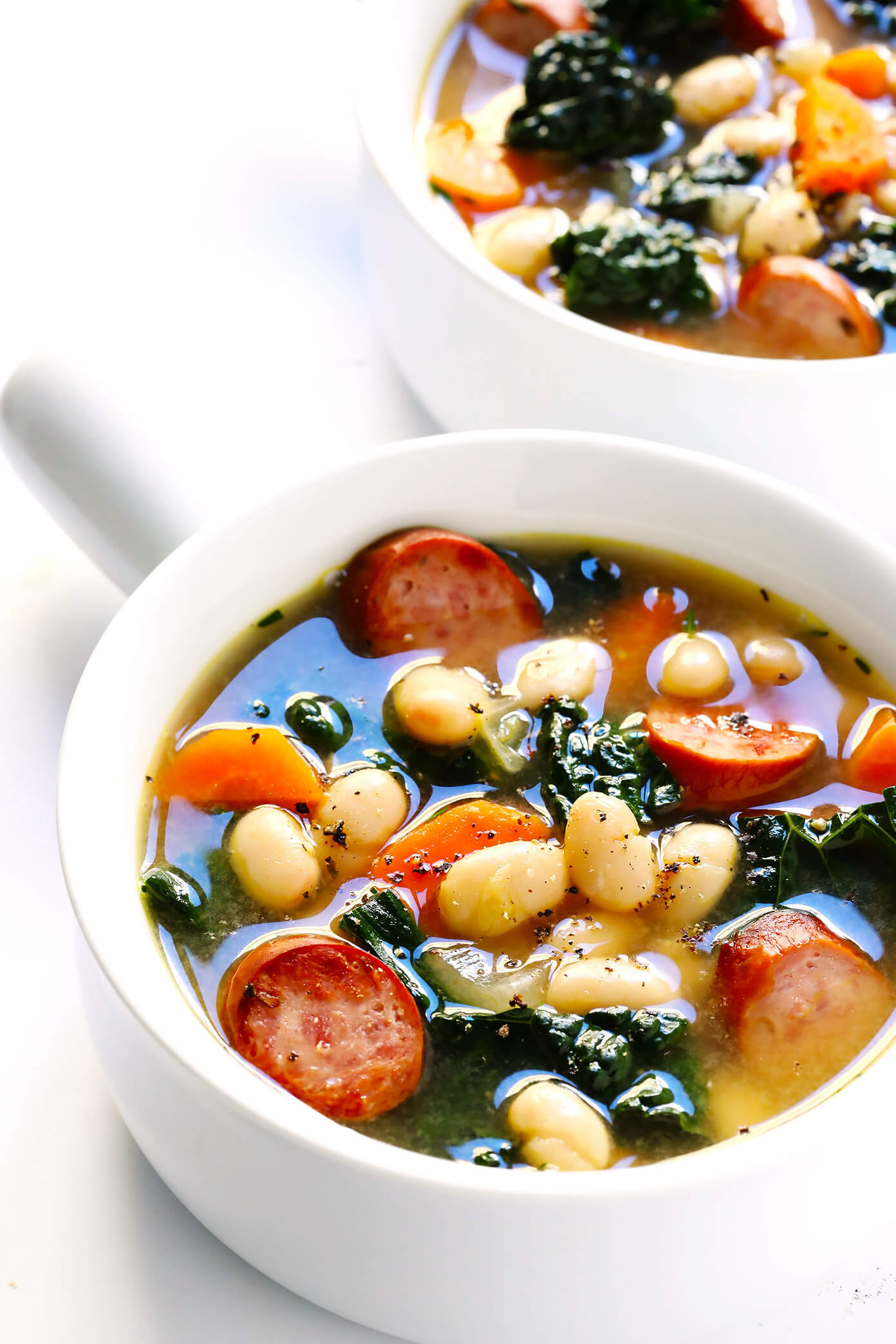 This Tuscan White Beans, Sausage and Kale Soup is one of my favorite winter dinner recipes. It's easy to make, full of cozy Italian flavors, and it's so warm and comforting. | Gimme Some Oven #souprecipe #healthysoup #italianrecipes