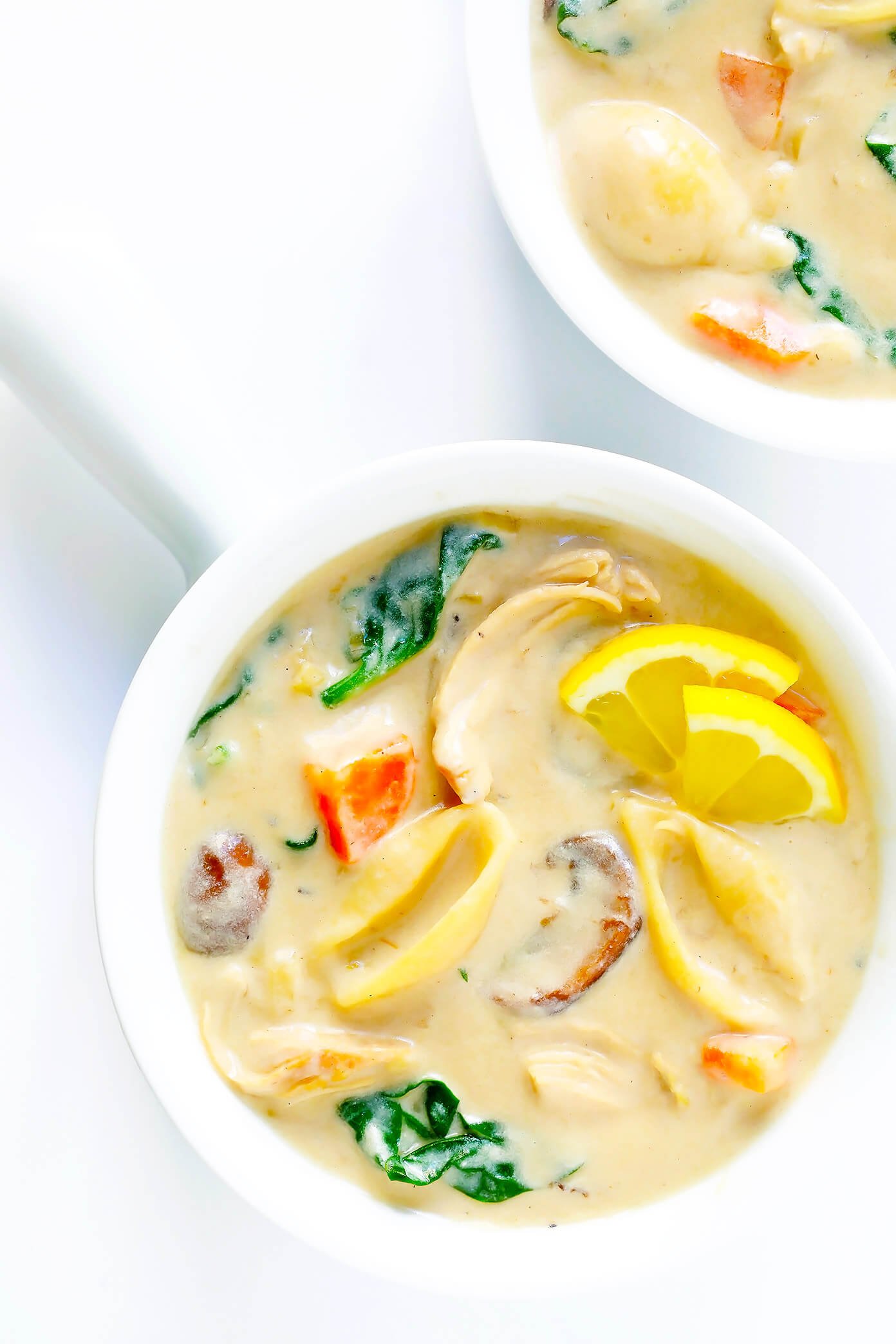 This Creamy Chicken Marsala Soup recipe is the BEST. It's made with pasta, mushrooms, carrots, and spinach...all simmered together in the most delicious creamy, garlicky, wine-infused broth. Top with Parmesan and lemon for a delicious, comforting dinner. | Gimme Some Oven #chickenmarsala #chickensoup #souprecipes #dinnerrecipes #comfortfood http://www.beincooking.com/