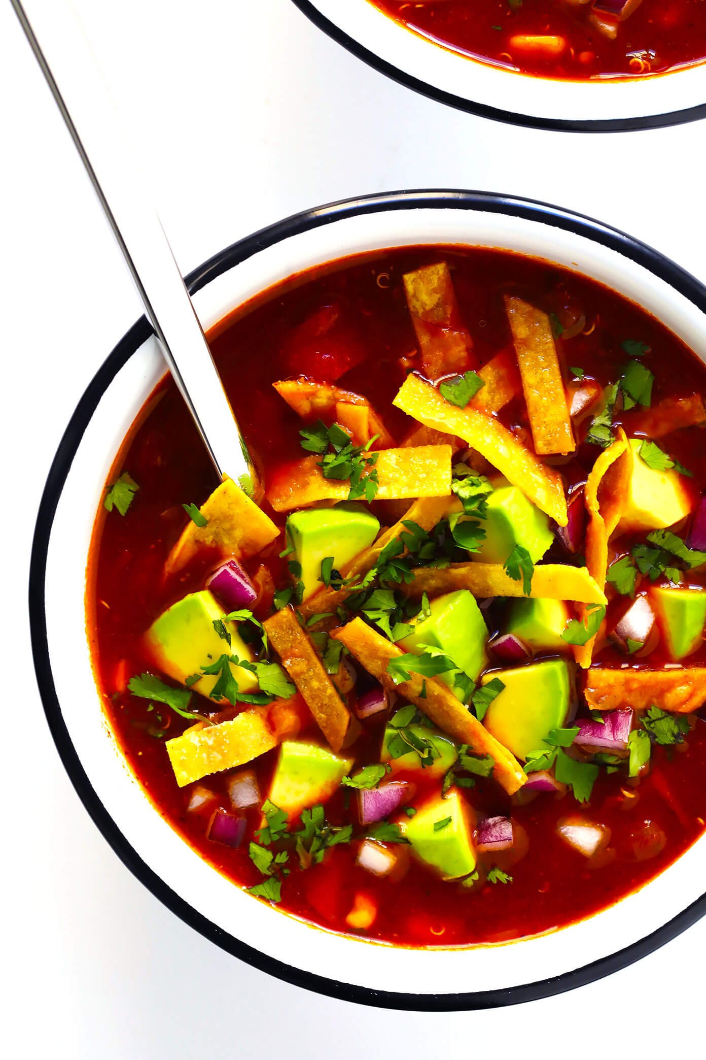 LOVE this Quinoa Tortilla Soup! It's naturally vegetarian, vegan and gluten-free. It's full of big flavors, made with the most delicious chile tomato broth, and best when piled high with lots of avocado and toppings. And it is totally hearty, comforting and delicious. Easy Mexican dinner for the win! | Gimme Some Oven #tortillasoup #mexican #glutenfree #vegan #vegetarian #soup Vegetarian Quinoa Tortilla Soup