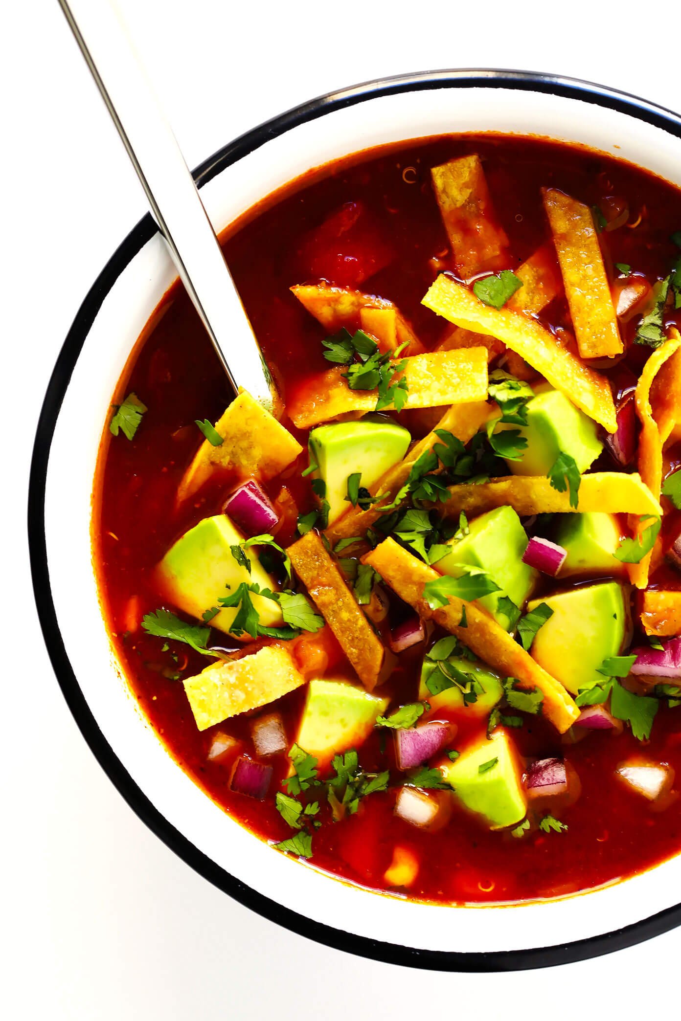 LOVE this Quinoa Tortilla Soup! It's naturally vegetarian, vegan and gluten-free. It's full of big flavors, made with the most delicious chile tomato broth, and best when piled high with lots of avocado and toppings. And it is totally hearty, comforting and delicious. Easy Mexican dinner for the win! | Gimme Some Oven #tortillasoup #mexican #glutenfree #vegan #vegetarian #soup Quinoa Tortilla Soup (Vegetarian, Vegan, Gluten-Free)