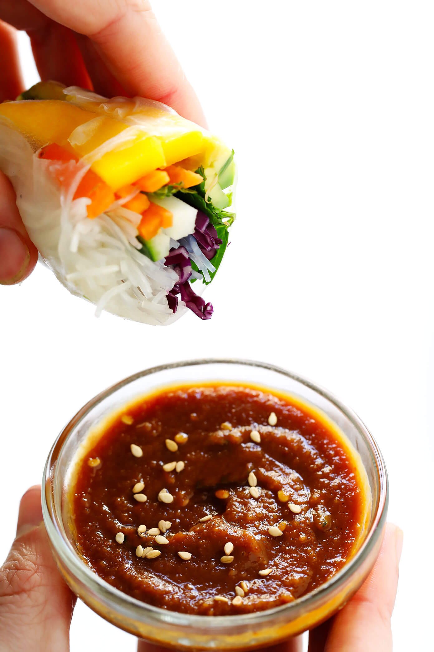 Easy Mango Avocado Spring Rolls dipped in a delicious peanut sauce