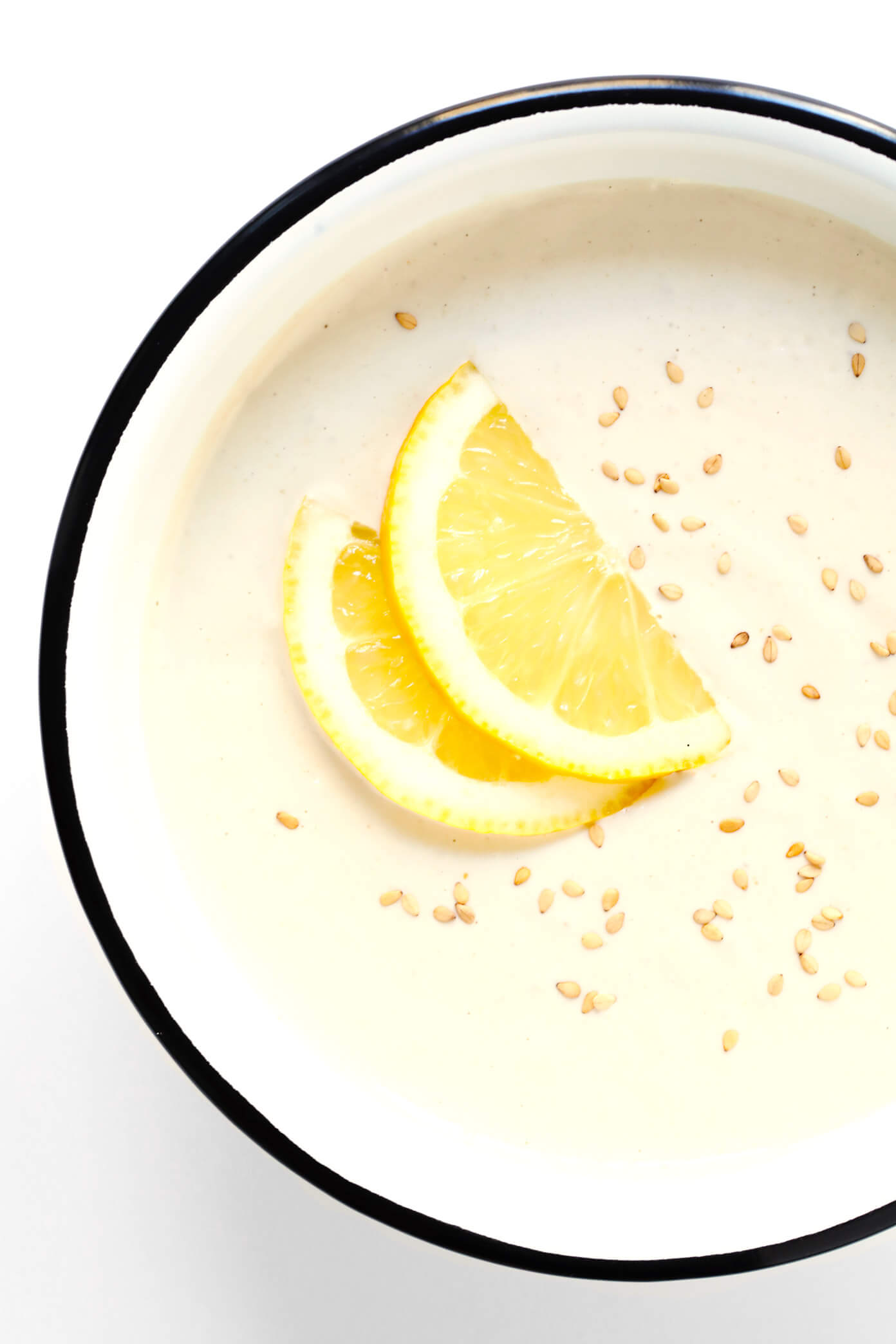 Blender Tahini Dip in a bowl sprinkled with sesame and lemon