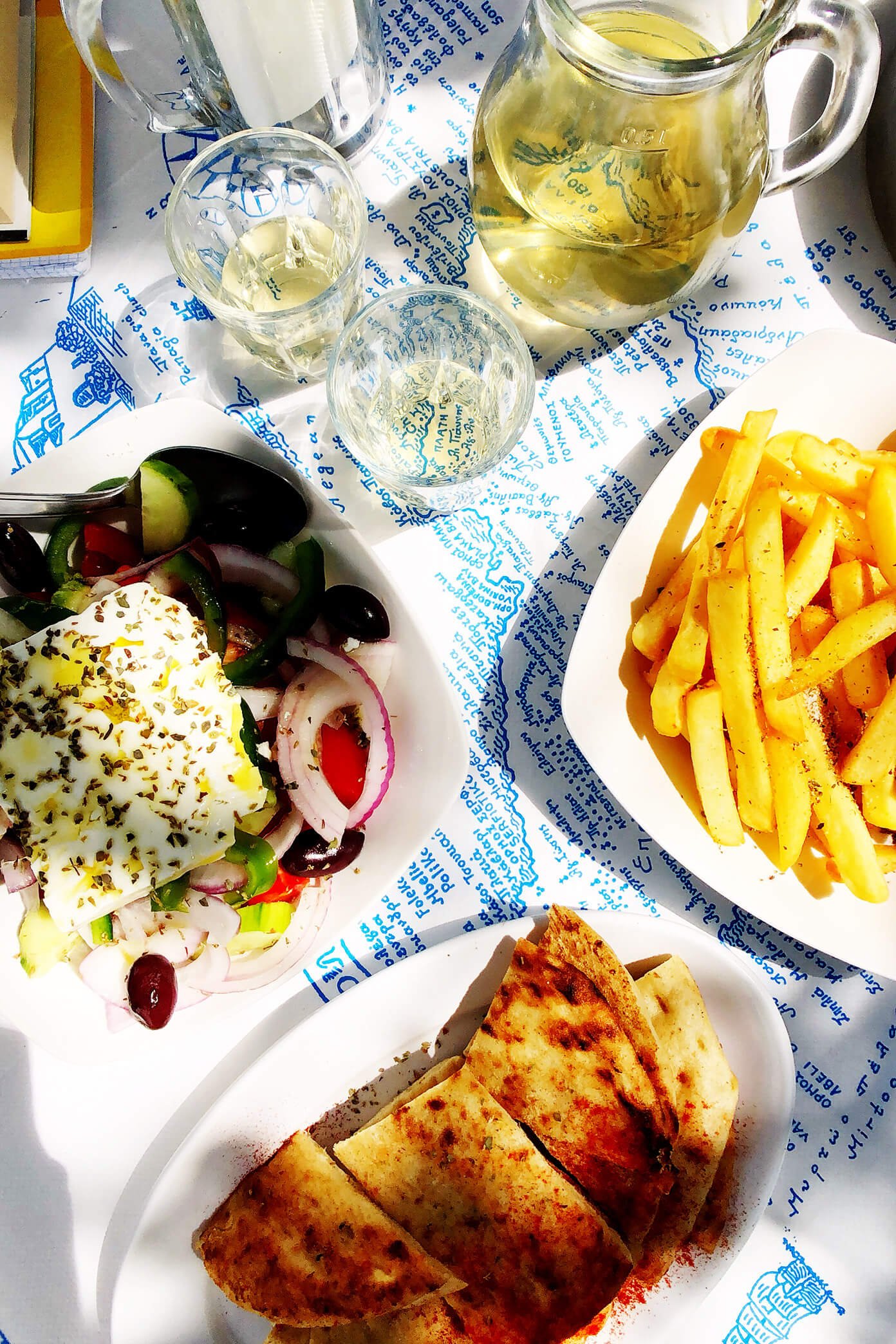 Greek Salad, Pita, Fries and Wine at Souvlaki Club Restaurant in Folegandros, Greece