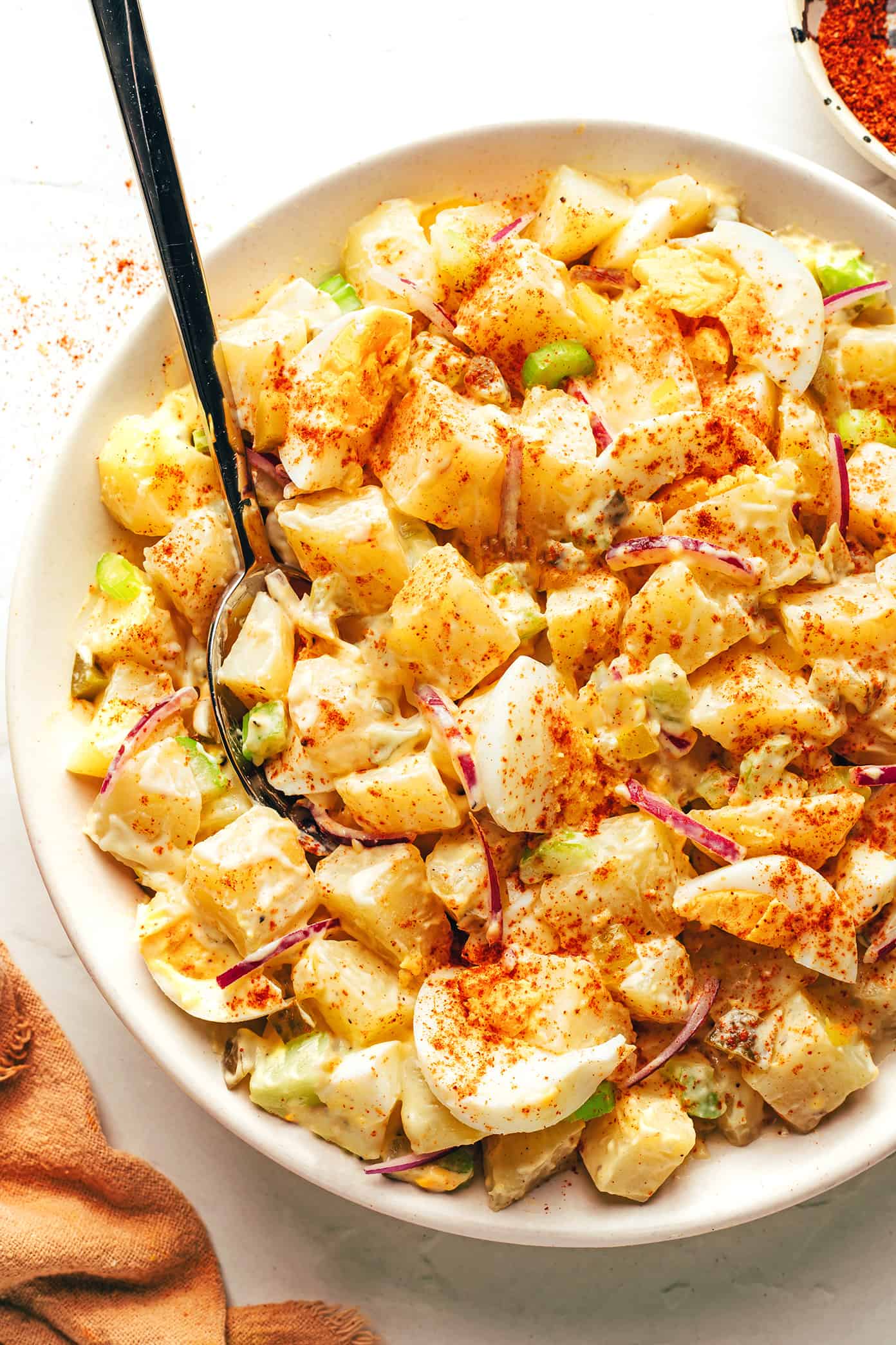 Classic potato salad in a bowl with spoon