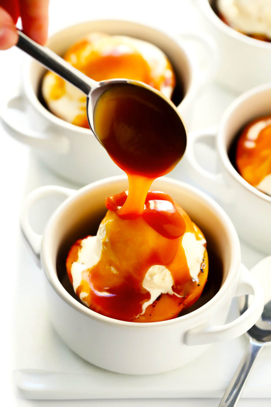 Grilled Peaches with Ice Cream and Bourbon Caramel Sauce